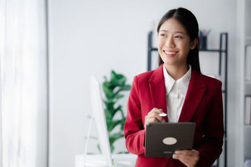 Businesswoman working in office, Asian female business owner conducts financial management, she set up startup company, modern female leadership. Business woman leader concept.