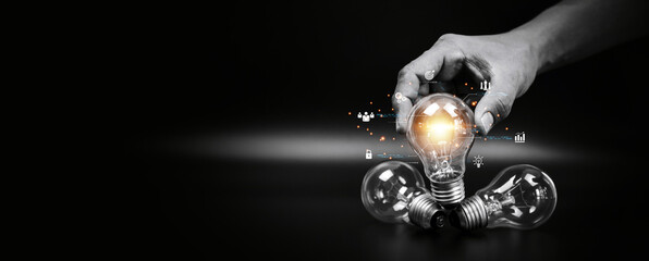 close up hand choose light bulb or lamp with icons for human resources or leadership and creativity 