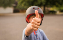 Boy Showing Thumbs Up While Wearing Helmet