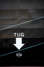 Close-up Of Tug Text With Arrow Symbol On Boat