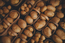 Close-up Of Fresh Potatoes In Baskets For Sale At Market