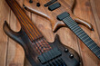 © Pavlo - Electric rhythm guitar and five-string bass photographed on a wooden surface.