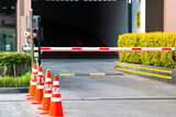 Fototapeta Desenie - security system for building access - barrier gate stop with toll booth, traffic cones and cctv
