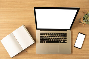 Wall Mural - laptop computer with blank white desktop screen on the desk with clipping paths. top view