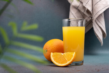 Wall Mural - Glass of fresh juice and ripe orange