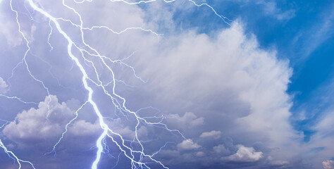 Wall Mural - lightning strikes between stormy clouds.