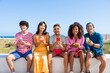 Multiethnic group of happy friends bonding and having fun at the beach on summer vacation - Multiracial real authentic people spending time together at the sea, concepts about youth and summertime