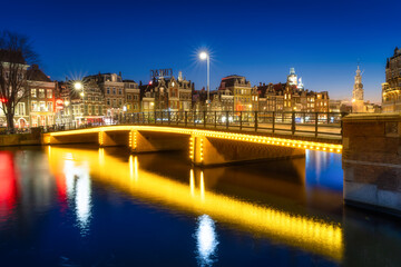 Wall Mural - amsterdam, netherlands. evening cityscape. dark sky and city lights. dutch canals. reflections on th