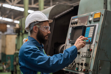 The technician is working in a steel factory. Engineer officer in engine control. Factory worker or engineer doing machine job in adept manufacturing workshop.