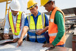 © chachamp - Portrait Asia man and team engineer hard working with paper work at precast cement factory
