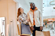 © Roman - cheerful positive man and woman get pleasure from shopping at Christmas together. Xmas sales they hold handbag at hands.