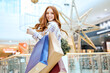 © Roman - cheerful girl gets pleasure from shopping at modern shopping center,lifestyle, hobby, interests. happiness, best day for shopping, successful goods, success
