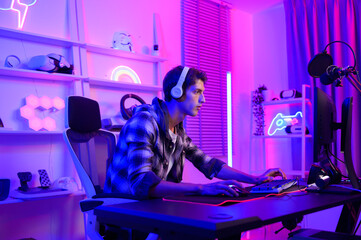 Young Caucasian man Pro Gamer have live streaming  and chatting  with his  fans at home