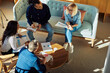 © Flamingo Images - Smiling group of diverse businesspeople meeting in an office lounge