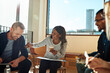 © Flamingo Images - Diverse group of businesspeople laughing together in an office meeting