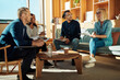 © Flamingo Images - Diverse group of smiling colleagues meeting together in an office