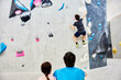 © Flamingo Images - Family watching a boy climbing in a gym
