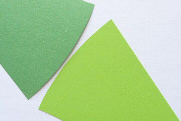 Wall Mural - two green paper shapes on blank paper