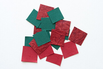 Wall Mural - small pile of green and red textured paper tiles on white