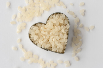 Wall Mural - Uncooked Sushi Rice in a Heart Shape