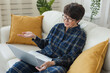 © satura_ - Work online remote from home concept. Woman relaxing in pajama while video call meeting