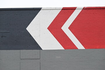 abstract painted arrow design on grey brick wall background
