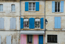 Old Exterior Vintage House In Italy With Blue And Pink Window Shutters