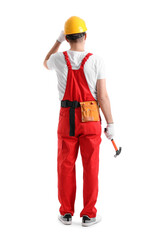 Canvas Print - Young carpenter with hammer on white background, back view