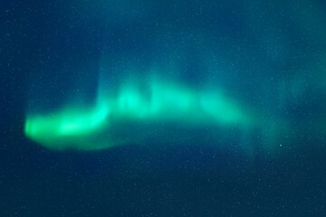 Wall Mural - Blue night starry sky and Northern lights. Green aurora borealis