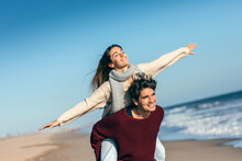Beautiful Young Couple In Love Enjoying The Day In A Cold Winter On The Beach.