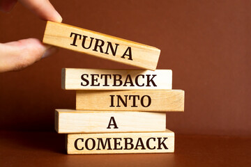 Wall Mural - Wooden blocks with words 'Turn a setback into a comeback'.