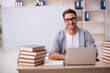 © Elnur - Young male student preparing for exams in the classroom
