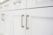© Jayson - Close up view of white kitchen cabinet