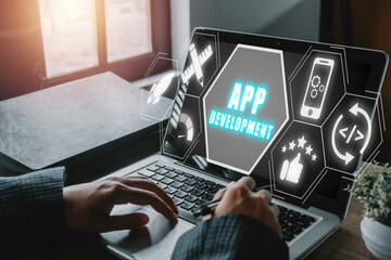 app development concept, person hand using laptop computer with app development icon on virtual scre