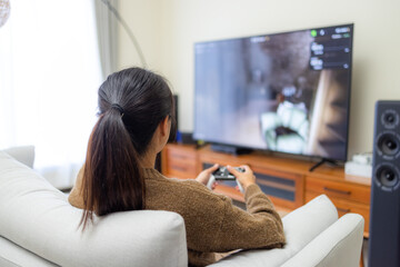 Woman play video game at home