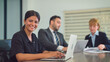 © Jestercine - Portrait of beautiful indian woman looking to camera with attractive smiling at office. She working at office with team. Business, Teamwork, Corporate, Lifestyle, Technology and Diversity concept.