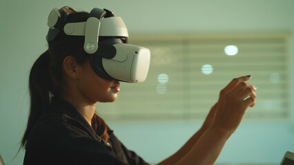 Beautiful indian girl wearing virtual reality headset. Woman playing using VR goggles at office. Technology, Lifestyle, Development, Business, Data Science, Metaverse and Communication concept.
