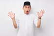 © Bangun Stock Photo - Surprised young Asian Muslim man raised hand with an open mouth and hears the good news isolated on white background. People religious Islamic lifestyle concept