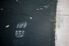 Close-up Of Shoe Print On Road