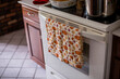 © Cavan Images - Close-up of dish towel against oven in kitchen at home