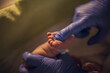 © Cavan Images - Cropped hands of pediatrician touching newborn baby's foot at hospital