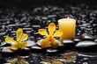 spa and zen concept ,yellow orchid,candle  close up with black zen stones, 