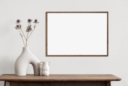 empty horizontal frame mockup in modern minimalist interior with plant in trendy vase on white wall 
