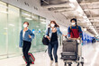 © Art_Photo - Young friend traveler in quarantine for coronavirus wearing surgical mask face protection with luggage flight travel before long travel vacation flight at International terminal airport