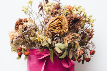 Poster - Flowers in a box. Dry flowers bouquet. Warm color flowers. Dried rose background. Aristic autumn floral texture. Beautiful shallow depth of field dry flower composition. Decoration on home wall.