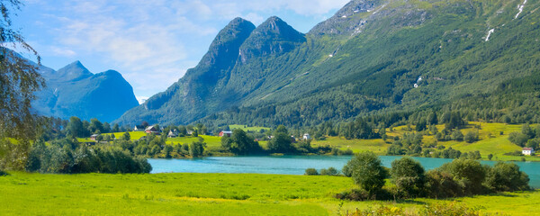 Norwegian landscape with Nordfjord fjord, summer mountains and village in Olden, Norway