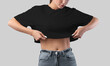 Mockup of a black crop top on a girl in gray jeans, taking off a canvas bella t-shirt close-up, isolated on background.