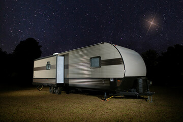 Wall Mural - Bright star shining over an RV on a clear night