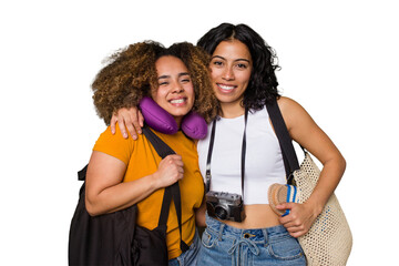 Two diverse friends on a beach vacation with vintage camera, beach bag, and travel pillow happy, smiling and cheerful.