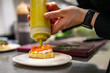 © pavel siamionov - man chef hand cooking Bruschetta with salmon and cream cheese on restaurant kitchen